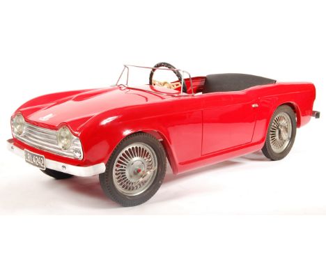 A rare original vintage 1960's Devillaine made Triumph TR4 child's pedal car. Metal body, in red, with silver coloured trim. 