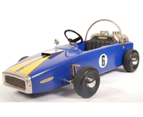 A rare unique vintage 1960's Lola pedal racing car. Metal body, in blue and yellow, fitted with various accessories including