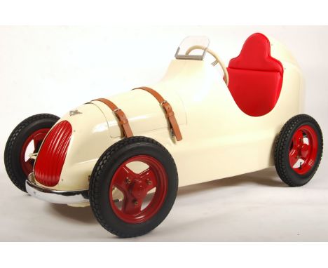 An incredibly rare original vintage 1940's Austin made Pathfinder child's pedal car. Metal body in cream, with chrome and red