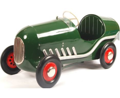 An original vintage Tri-ang / Triang made Brookland's Racer child's pedal car. Metal body in British Racing Green colours, th