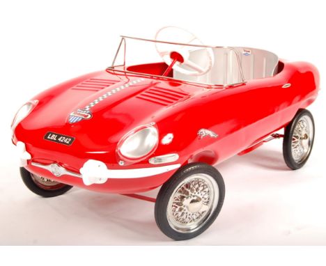 An incredible vintage 1960's Triang / Tri-ang made E-Type Jaguar child's pedal car. Metal body, in red, with Tri-ang makers d