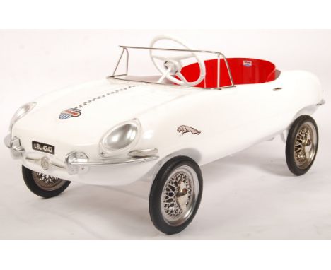 An incredible vintage 1960's Triang / Tri-ang made E-Type Jaguar child's pedal car. Metal body, in white, with Tri-ang makers