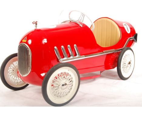 An original vintage Tri-ang / Triang made Racer child's pedal car. Metal body in red with No.7 decals. The body fitted with a