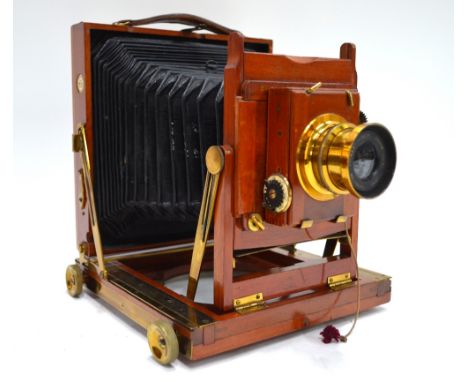 A Thornton Pickard brass-mounted mahogany half-plate camera with Time & Inst. shutter and Beck Symmetrical Lens in original c