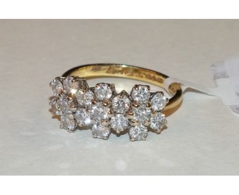 A diamond cluster ring claw-set seventeen brilliant-cut diamonds, in 18ct yellow and white gold mount, size O½, 4.5g.