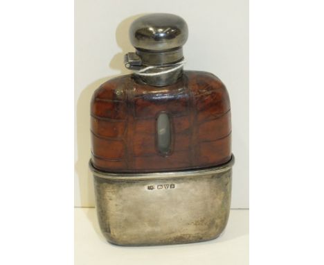 A George V silver whisky flask with silver twist lid and cup on glass flask, with leather jacket to top, 10.5cm, Chester 1924