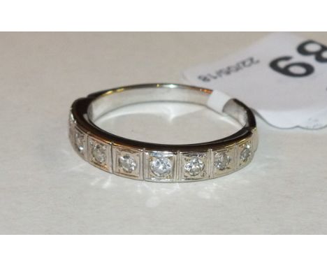 An 18ct yellow and white gold half-eternity ring set nine brilliant-cut diamonds, size R½, 4g.