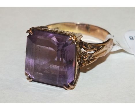 A 14k gold dress ring set a large step-cut amethyst, size O½, 7g.