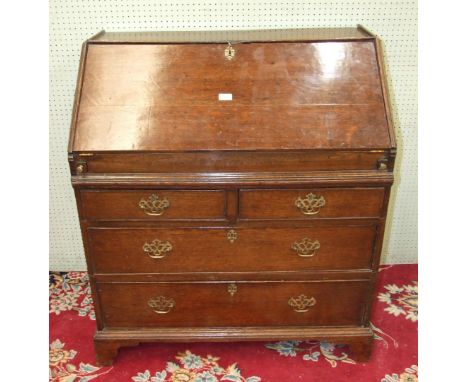 A 19th century oak bureau, the rectangular top above a fall front opening to reveal a fitted compartment of drawers, pigeon h