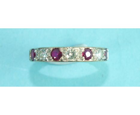 A ruby and diamond half-eternity ring alternately-set four round-cut rubies and three brilliant-cut diamonds, in 18ct gold mo