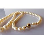 A mid-century single row of sixty-nine graduated Akoya cultured pearls measuring 6mm to 9.7mm