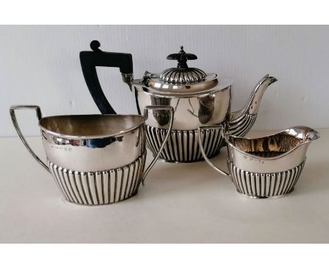 A late Victorian silver bachelor tea set with half-fluted decoration, teapot and jug by Jay, Richard Attenborough &amp; Co., 