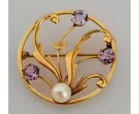 An Edwardian circular brooch with amethyst and pearl decoration, 33mm, unmarked, 4.15g