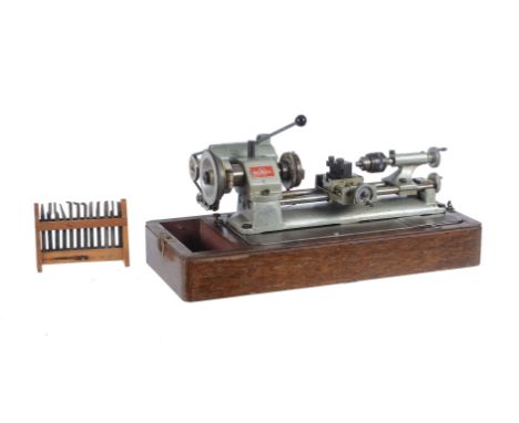 An Emco-Unimat watchmakers/model makers lathe, fitted with three jaw chuck, cross-slide with fitted tool post. Accessories to