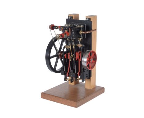 A well engineered model of a live steam wall mounted engine, having twin cylinders, open crank with connecting rods, spoked f