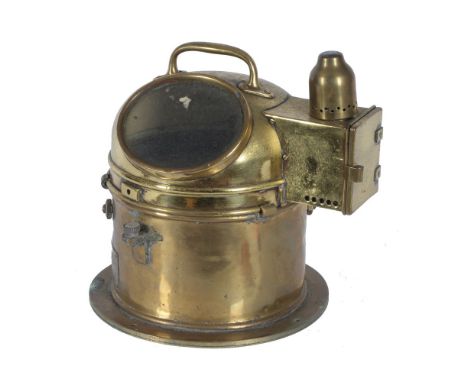 A ships compass in polished brass cylindrical case, with large handle to top. Spirit burner and label 'Patt 0183. No 18472.H'