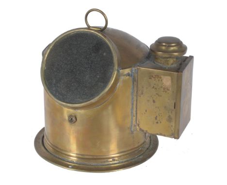 A ships compass in polished brass cylindrical case, with ring handle to top and spirit burner. Diameter 23cm.