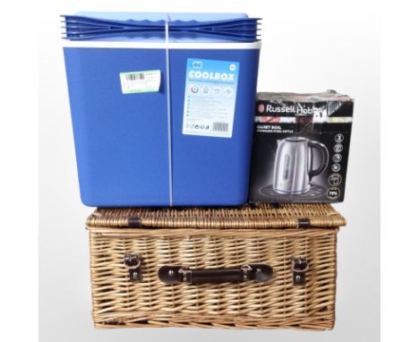 A cool box, together with a kettle and a wicker hamper.