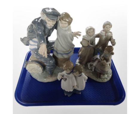 A Lladró and two Nao figure groups, all as found, tallest 32cm.