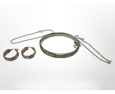 A silver bangle together with a pair of three-tone silver earrings and two silver bracelets. CONDITION REPORT: 25.2g.