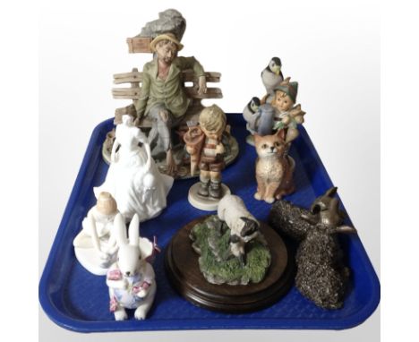 A Capodimonte figure of a tramp seated on a bench, together with other figures including Goebel, Country Artists, Royal Doult