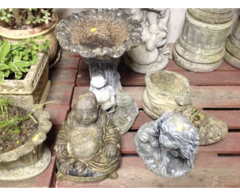A concrete birdbath, height 47cm, and three further ornaments including Buddha, dog and a boot planter.