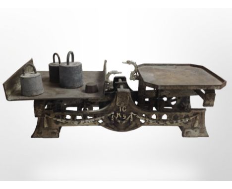 A 19th-century set of cast iron scales, with several weights.