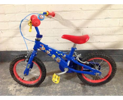 A child's bike, together with a Flymo garden vacuum and several tools.