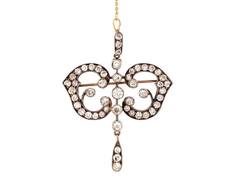 A late Victorian/early Edwardian diamond set brooch pendant, comprising five graduated old cut diamonds rubover set to the ce