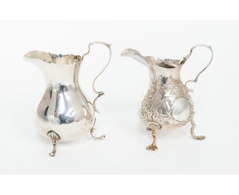 A George II style silver plain cream jug, pear shaped on three shell and scroll feet, by William Aitken, Chester, 1899, 3.01 