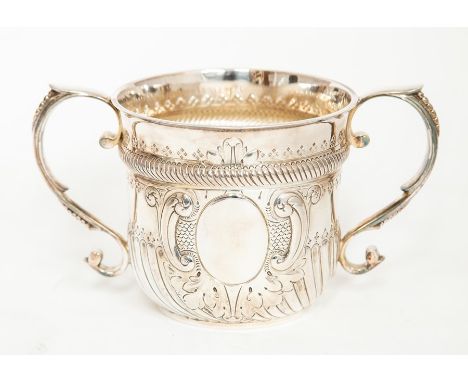 A Victorian silver large&nbsp;two handled porringer, fluted section above vacant cartouche surrounded by scroll, scale and ac