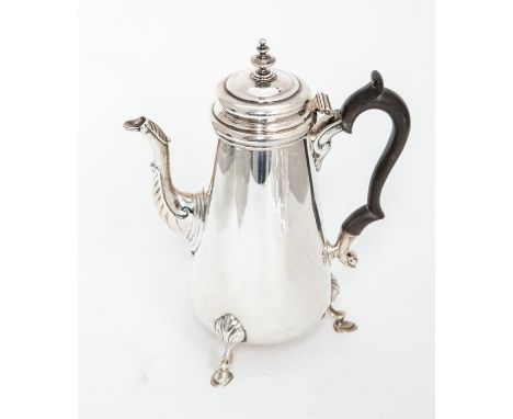 An Edwardian silver plain tapering cylindrical coffee pot, raised on three shell and hoof feet, ebonised S scroll handle, the