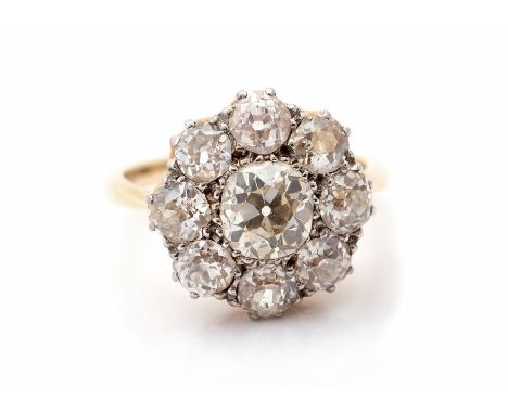 A diamond flower head 18ct gold cluster ring, comprising old cut diamonds, the principal stone weighing approx. 1 carat, with