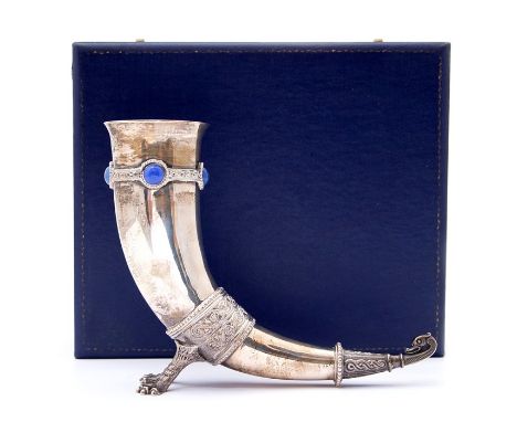 An Elizabeth II silver Saxon style drinking horn, raised on twin claw feet, the top with a band of intertwining decoration se