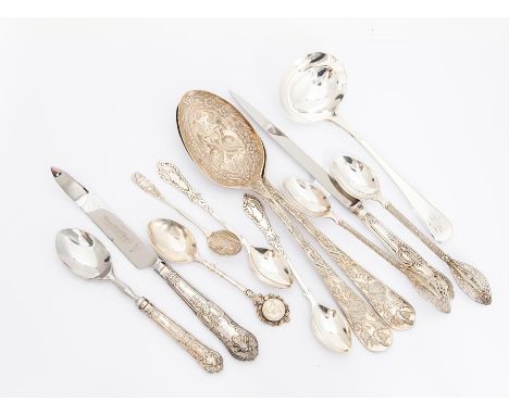 A collection of silver and white metal flatware including: a pair of Continental berry spoons, the bowls chased with storks, 