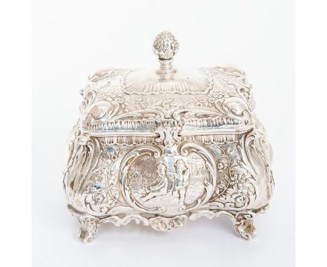 A late Victorian silver tea caddy,&nbsp;bombe shaped profusely chased with scrolling foliage and acanthus leaf corner with ca