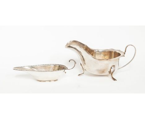 A group of George V silver including: a large oval sauce boat, scallop edge on three scroll feet, by E Viners, Sheffield, 193