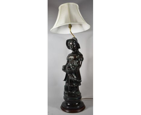 A Glazed Ceramic Figural Table Lamp in the Form of Girl with Basket, Complete with Shade, 104cm high (max), Small Chip to Dre