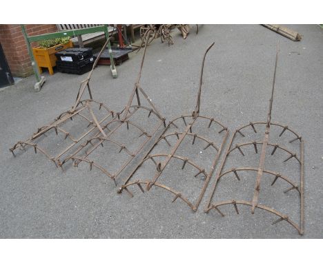 Vintage agriculture - four cast iron barrow harrows.