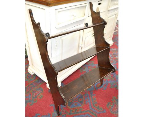 A stained pine three shelf wall rack