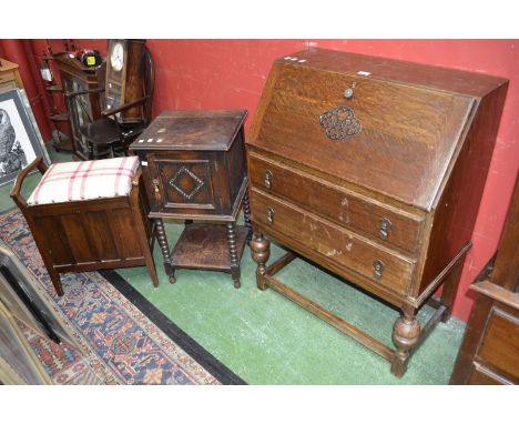 A 1940's oak bureau; an oak carved smoker's cabinet with bobbin turned supports; a mahogany piano stool