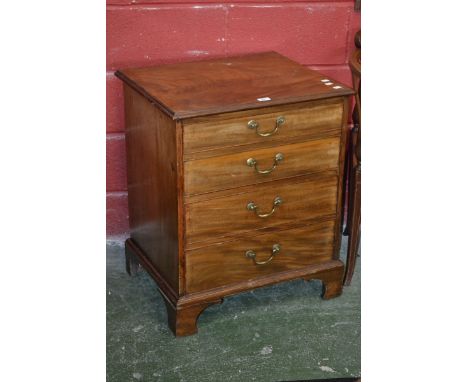 A mahogany commode in the form of a four drawer chest, hinged top, the top two faux drawers raising to reveal the chamber pot