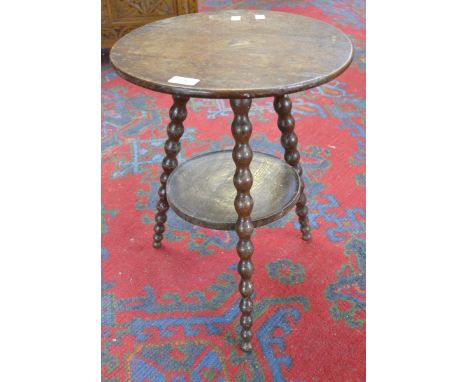 An oak cricket table of small proportions, circular top, dished undertier, tapering bobbin turned supports. 49cm high x 38cm 