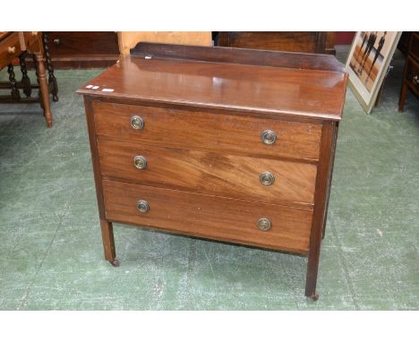 A mahogany chest, galleried back, oversailing top, three graduated drawers, brass roundels and loop handles, square supports,