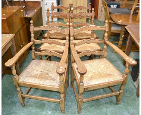 A set of six rush seated ladder back dining chairs including two carvers