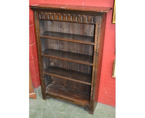 A floor standing oak four shelf open bookcase. 118cm high x 77cm wide x 25cm deep.