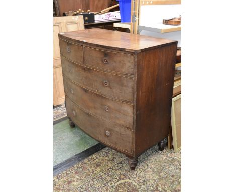 A Victorian mahogany caddy topped bowfront chest of drawers, two short cockbeaded drawers over three graduated long, turned f