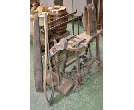 A vintage saddle makers bench; two saddle makers vices; cast fire dogs; two trestle rests; a carriage jack, etc.