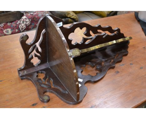 An unusual brass mounted corner shelf, shaped and pierced sides and support bracket.