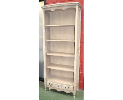 A contemporary painted bow front five shelf bookcase, long drawer to base, shaped apron, turned feet. 192cm high x 81cm wide 